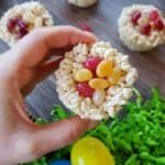 Crispy rice snacks topped with jellybeans held in someone's hand.