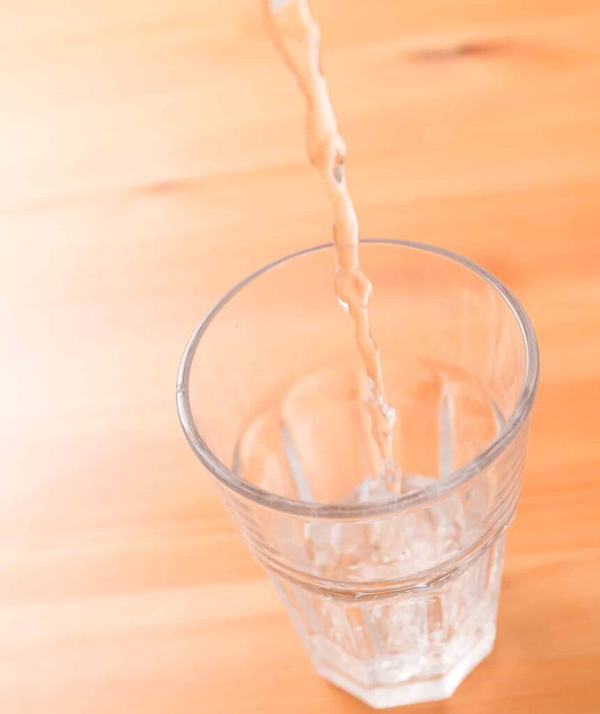 An image of water pouring into a glass.